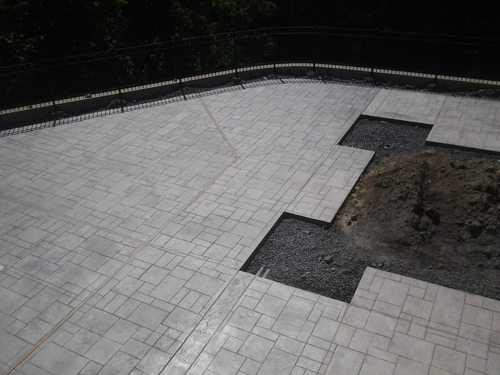 Residential paver installation coordinated with surrounding hardscape